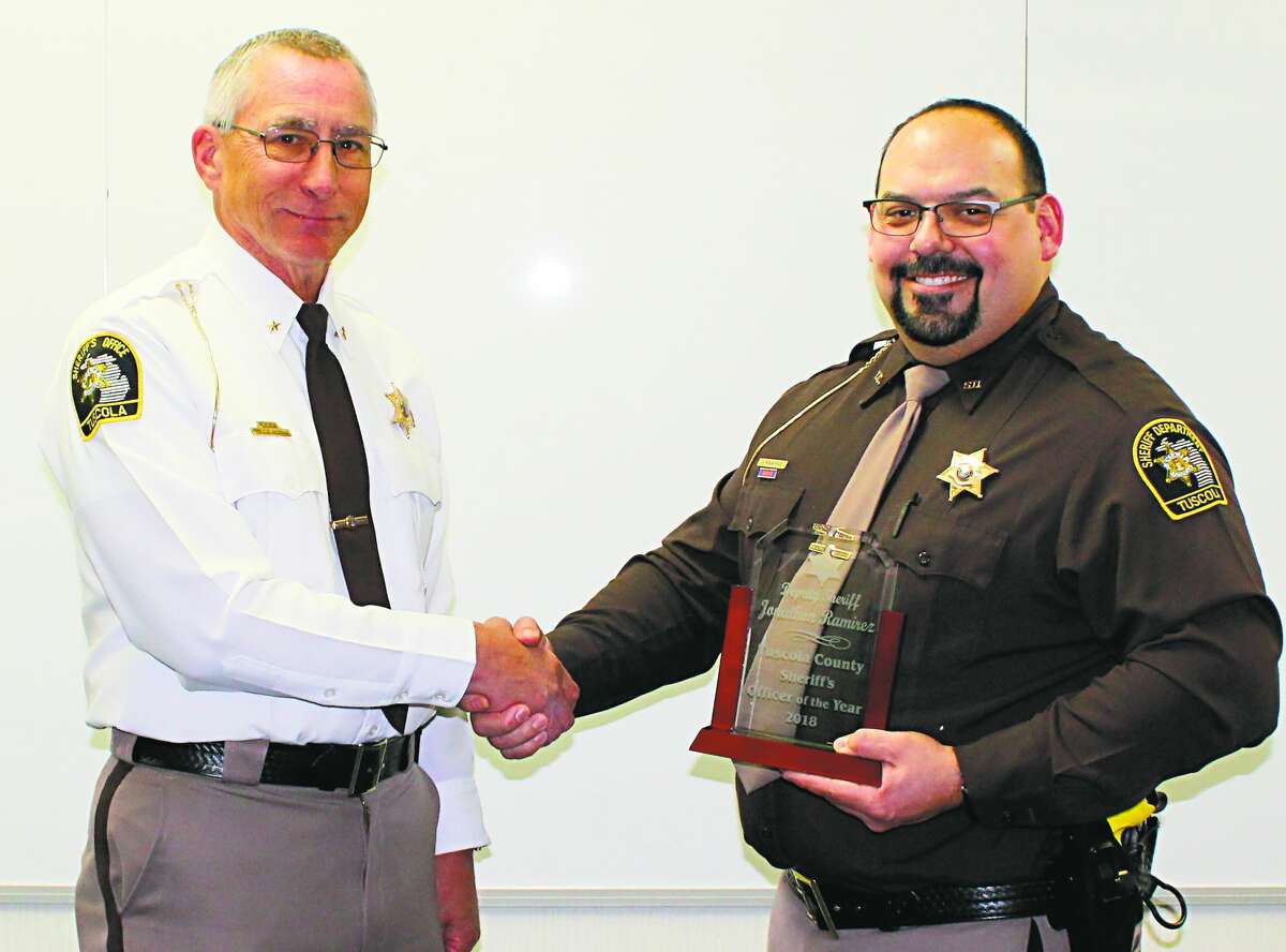 From left, Tuscola Sheriff Glen Skrent awards the department’s Officer of the Year honors to Deputy Jonathon Ramirez, who also received a citation for bravery.