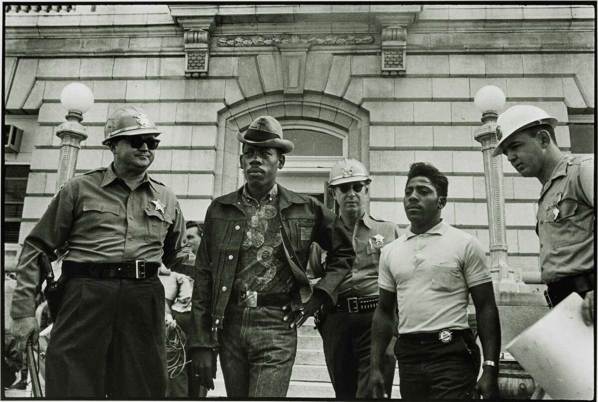 Danny Lyon's 1963 photograph depicting a sheriff arresting voter registration workers in Selma, Alabama, is part of a series of images that Lyon shot across the south documenting the civil rights movement.