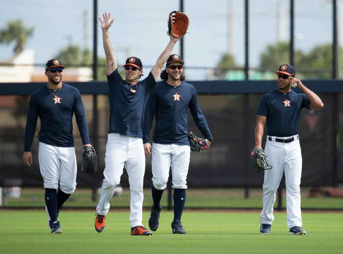 Houston Astros right fielder Josh Reddick, second left, waves to live batting practice hitters at the end of a session with fellow outfielders George Springer, from left, Jake Marisnick and Michael Brantley at Fitteam Ballpark of The Palm Beaches on Day 7 of spring training on Wednesday, Feb. 20, 2019, in West Palm Beach.