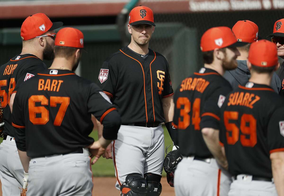San Francisco Giants' Buster Posey, center, works out during a spring training baseball practice, Friday, Feb. 15, 2019, in Scottsdale, Ariz. (AP Photo/Matt York)