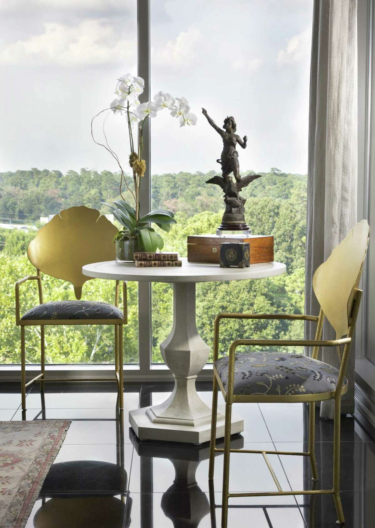 In a large room, create a second smaller seating area, like this corner nook with two chairs and a small table. (Room by Connie LeFevre of Design House)