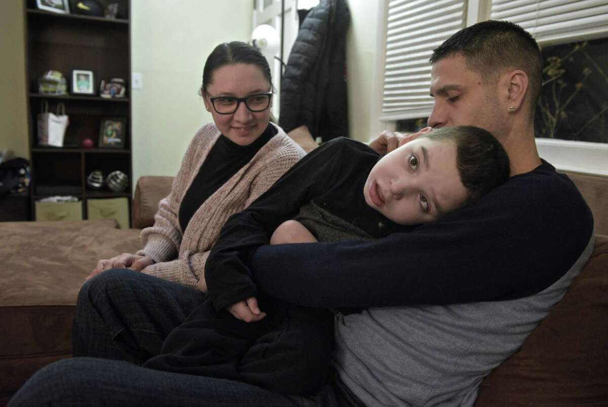 Above and below, Jared Carreras, 12, with his mother Shirley Correia and step-father Jayce Correia in their Brookfield home last week.