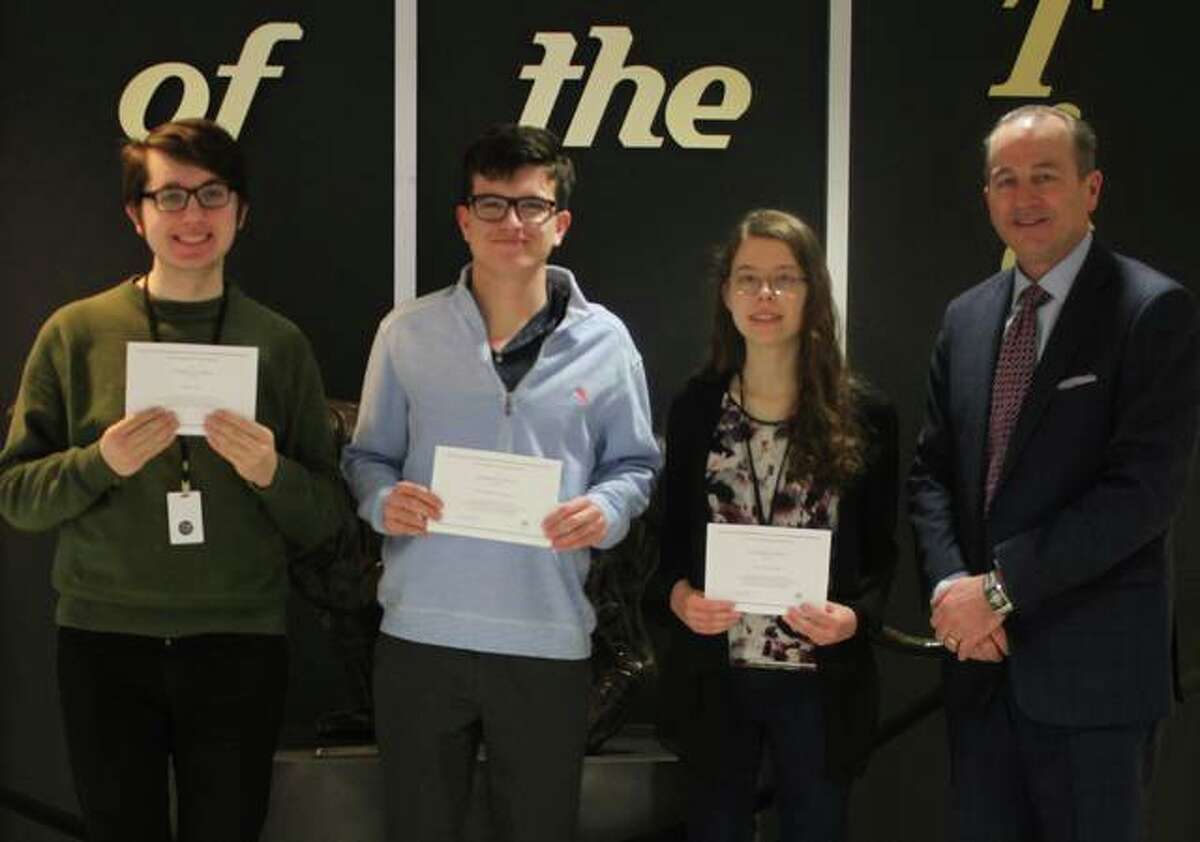 Ryan Ash, Christopher Byron, and Adrienne Rose receive their 2019 National Merit Scholarship Program Finalists certificates from EHS Principal Dr. Dennis Cramsey.