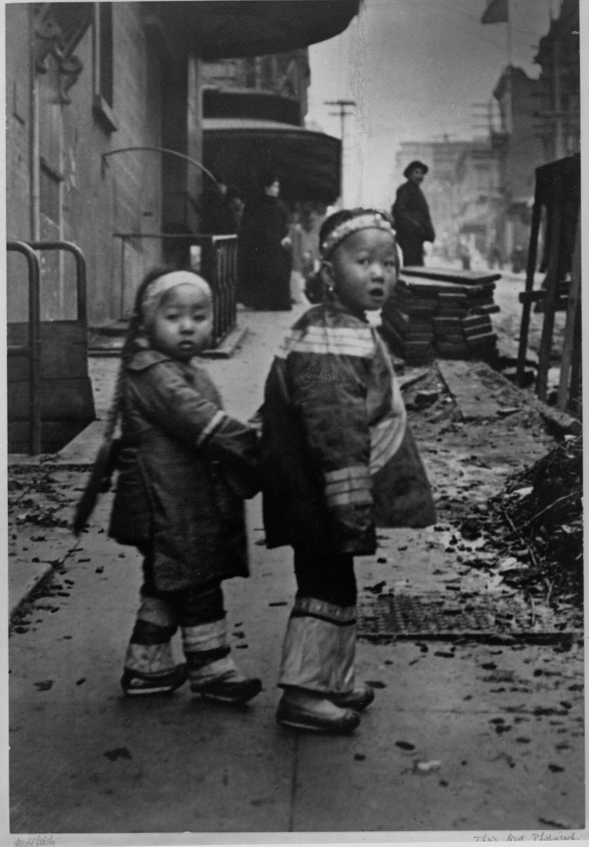Historic photos of SF Chinatown before the 1906 earthquakeTwo little sisters hold hands as they walk down the street in Chinatown, San Francisco, ca. 1890s.