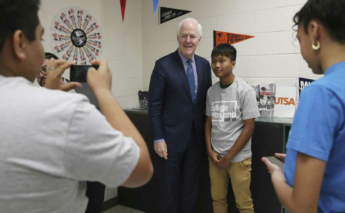 U.S. Sen. John Cornyn, R-Texas, poses for a picture with Wrenn Middle School Eighth-grader Sai Lin as the senator meets with school administrators from Edgewood, SAISD and Somerset along with students at Gus Garcia Middle School to discuss the federal grant program, GEAR UP, and legislation to modernize it on Thursday, Feb. 21, 2019. GEAR UP is a college/career readiness grant that Edgewood, SAISD and Somerset uses to begin advising kids as early as middle school. (Kin Man Hui/San Antonio Express-News)