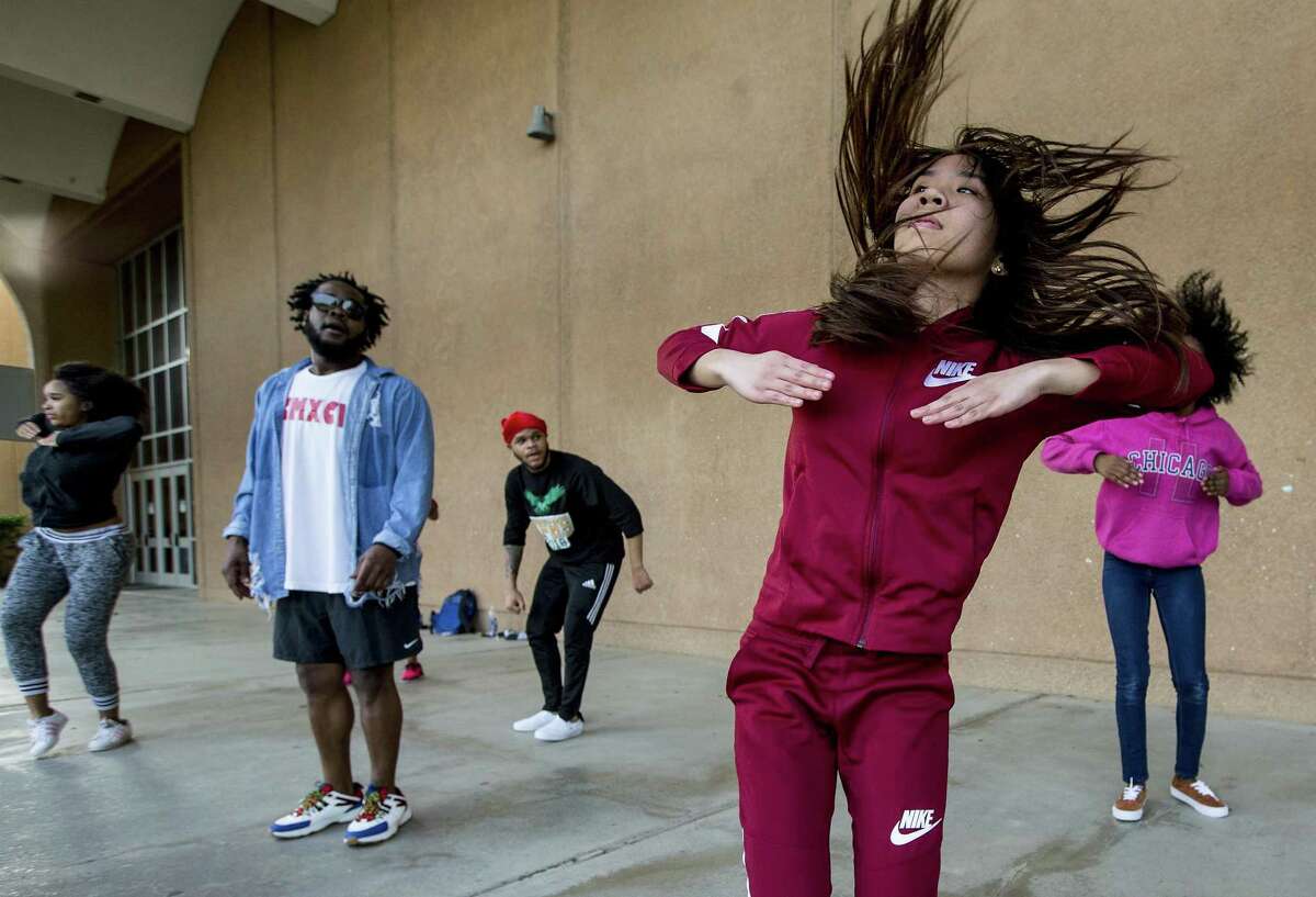 Geraldine De Paula, far right, works on a step routine with the Royal Duchess and D.U.K.E.S. community step teams while preparing to participate in an upcoming competition with sponsor Bryce Dill, left center, on Thursday, Feb. 14, 2019, in Spring.