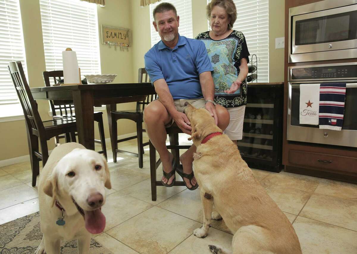 Richard and Maxine Kelley in their home with their labs, Hunter, left, and Hondo on Friday, July 20, 2018 in Tomball. Richard fell and hit head on corner of his kitchen island in January, a couple days later he walked into a freestanding ER where a doctor saw him for a few minutes, provided no treatment except a nurse giving him some steri-strips. The visit was coded as mid-level severity level and the bill was $1000 which insurance paid $300, leaving them with a $800 out of pocket cost. ( Elizabeth Conley / Houston Chronicle )