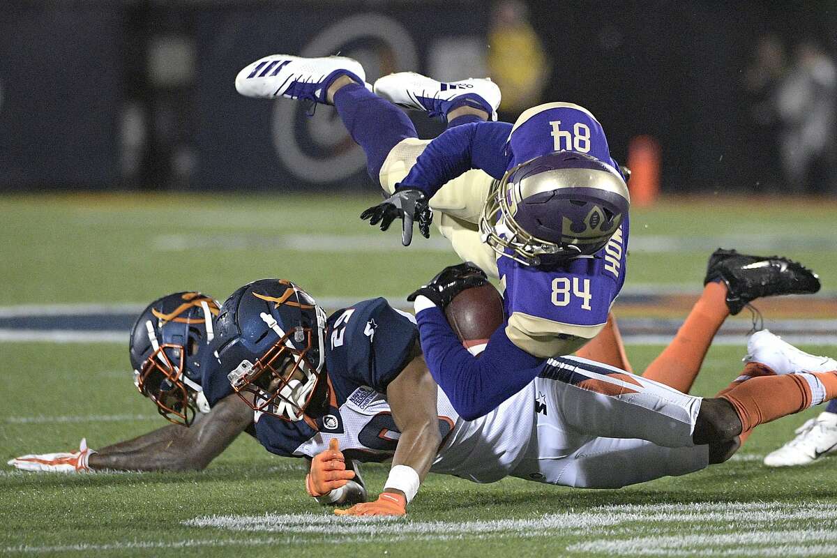 FILE - In this Feb. 9, 2019, file photo, Atlanta Legends receiver Bug Howard (84) is tackled by Orlando Apollos safety Will Hill and defensive back Keith Reaser (29) after catching a pass during the first half of an Alliance of American Football game, in Orlando, Fla. Almost no one knows the players, and there’s virtually no history to look back on. But that’s not stopping people from making _ and bookmakers from taking _ bets on America’s newest professional football league, the Alliance of American Football (AAF).(AP Photo/Phelan M. Ebenhack)