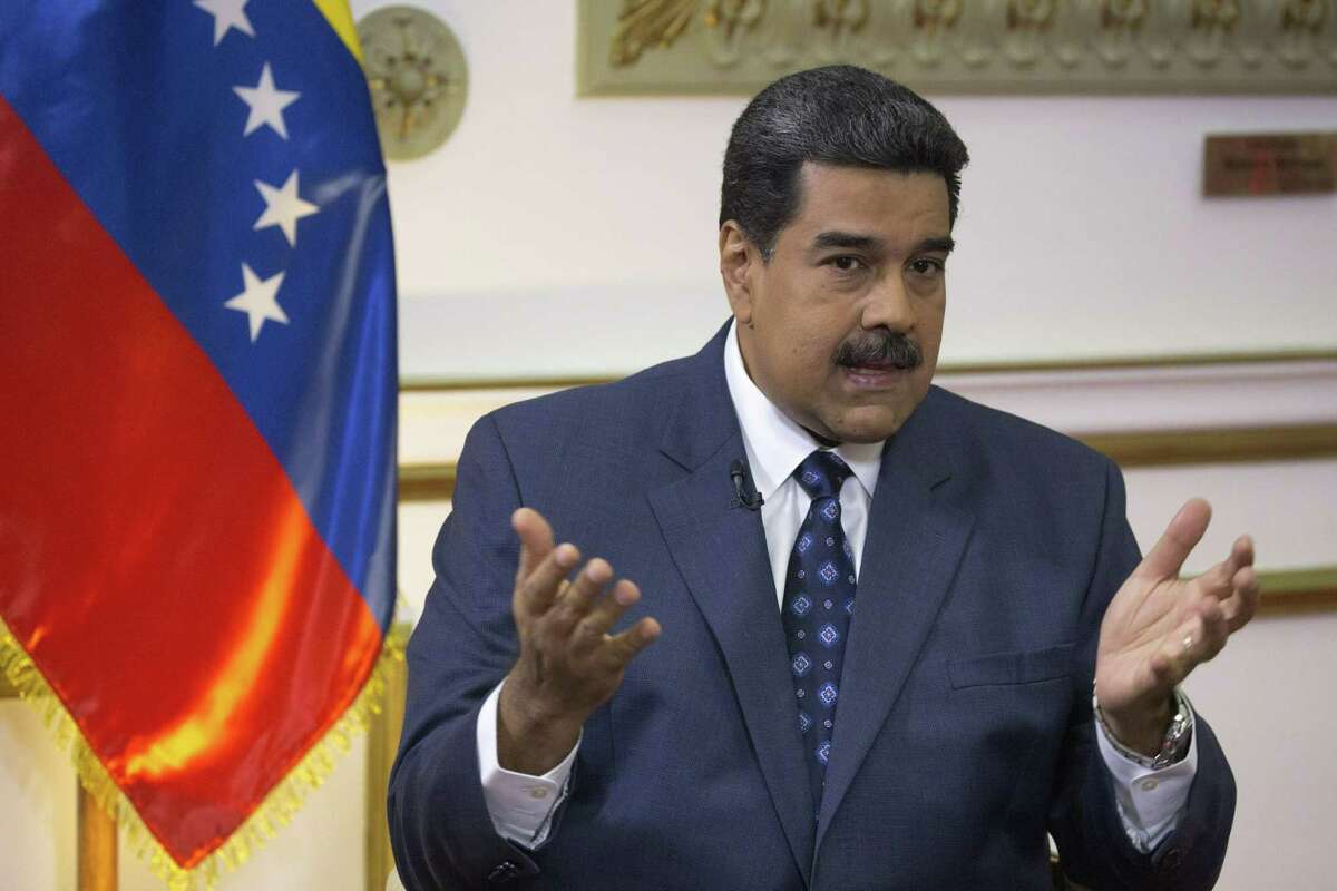 Venezuela's President Nicolas Maduro speaks during an interview with The Associated Press at Miraflores presidential palace in Caracas, Venezuela, Thursday, Feb. 14, 2019. Even while criticizing Donald Trump's confrontational stance toward his socialist government, Maduro said he holds out hope of meeting the U.S. president to resolve an impasse over his recognition of opponent Juan Guaido as Venezuela's rightful leader. (AP Photo/Ariana Cubillos)