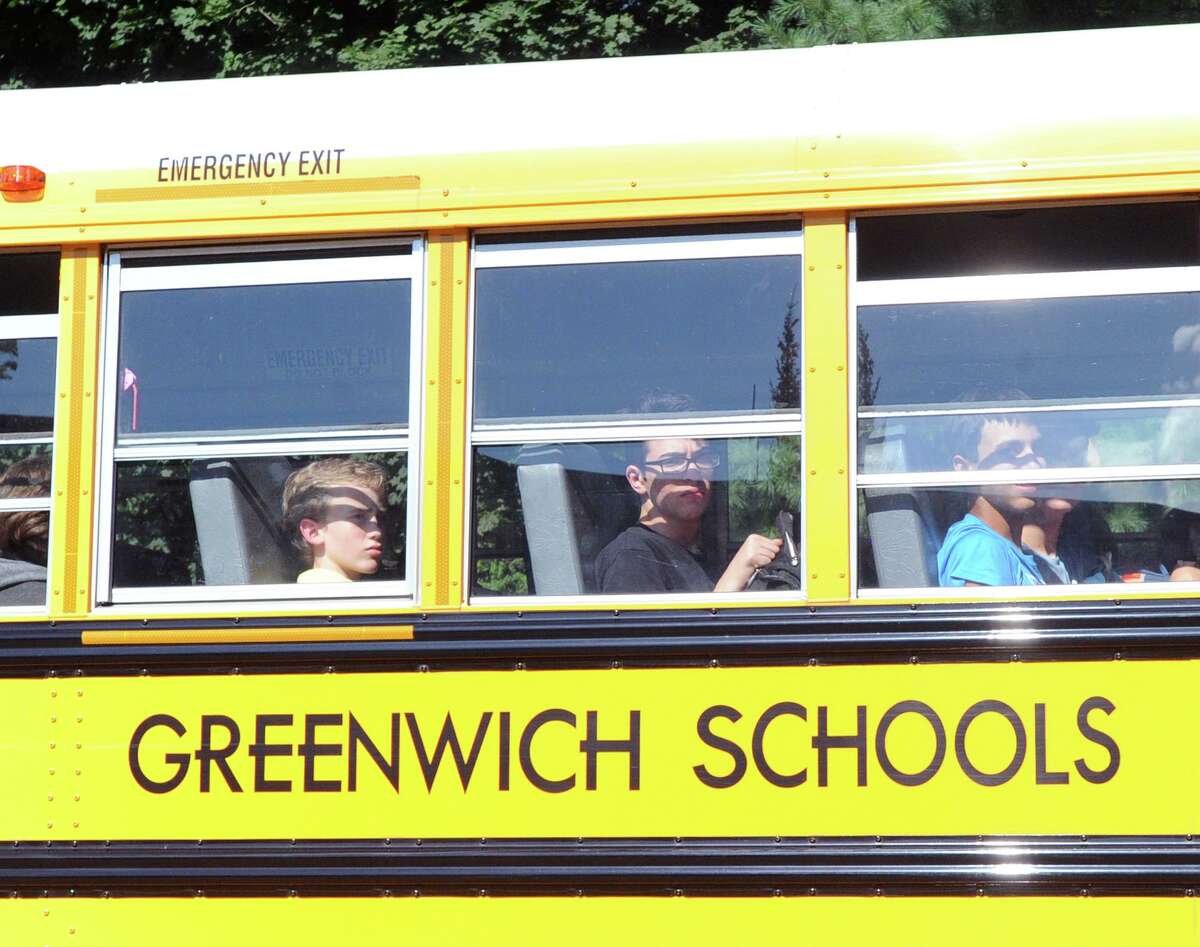 GHS students ride a school bus on Hillside Road in front of Greenwich High School during dismissal on the first day of school in Greenwich, Conn., Thursday, August 30, 2018.