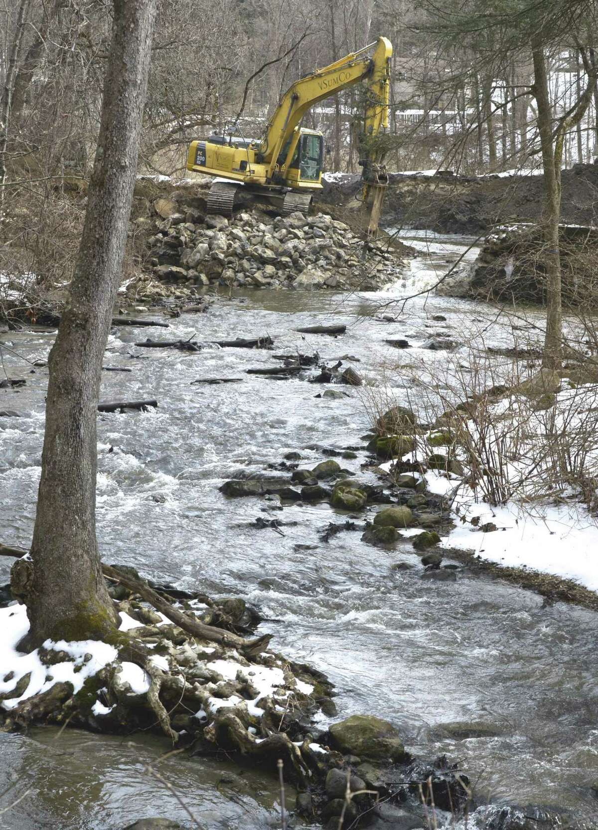 Excavator operator Jarrod Martellacci, works on removing the Old Papermill Dam on the East Aspetuck River. The dam belongs to the Ousatonic Fish & Game Protection Association and its removal is being overseen by the Nature Conservancy. Friday, February 22, 2019, in New Milford, Conn.