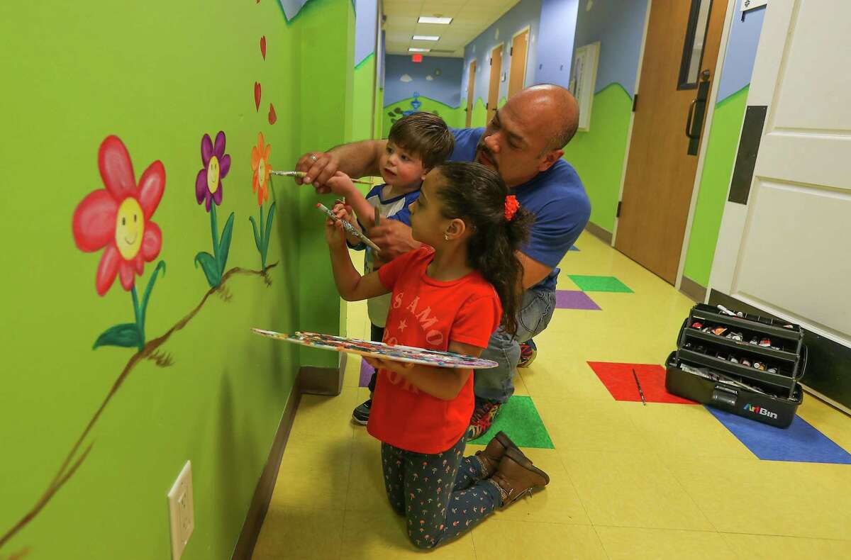Oscar Spivey and his daughter Sophia, 6, work on a mural at Bering United Methodist Church. Oscar and his husband Mitch drive 41 miles each way from their home in Fulshear to worship at Bering, which Mitch calls “the most welcoming place I’ve ever experienced.”