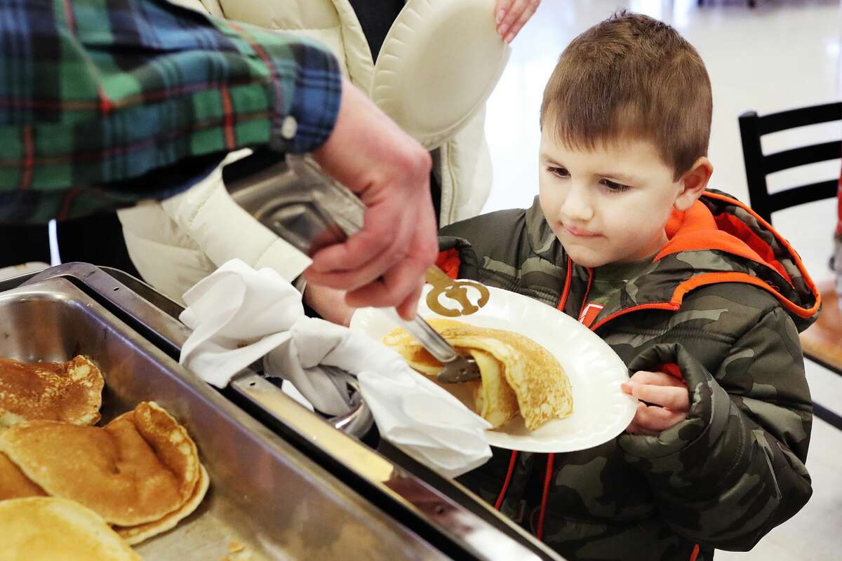 Gabriel Mabile of Midland, 4, watches as a volunteer serves him pancakes during the 46th Annual Rotary Pancake Supper & Fundraiser on Thursday, Feb. 21, 2019 at H. H. Dow High School. (Katy Kildee/kkildee@mdn.net)