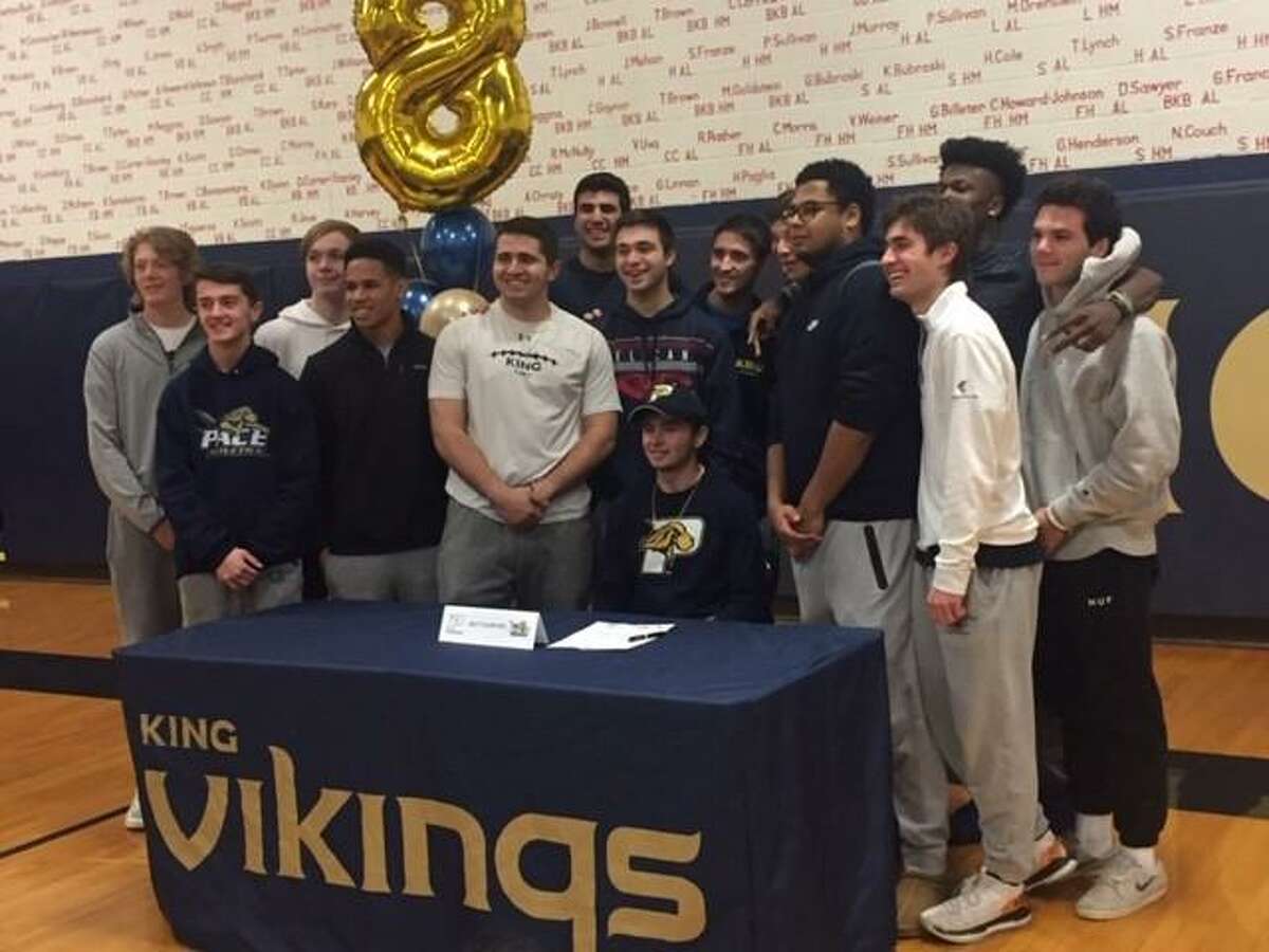 Matt Garavel, seated, celebrates with his King School football teammates Friday after signing his letter of intent to play football at Pace University in the fall.