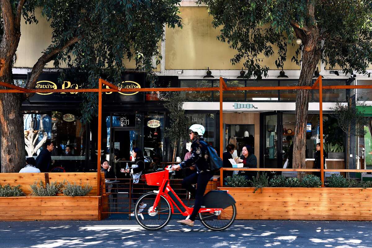 People lunch at a public parklet in front of Patxi�s Chicago Pizza and Souvla, located in the 500 block of Hayes St., in San Francisco, Calif., on Friday, February 22, 2019.