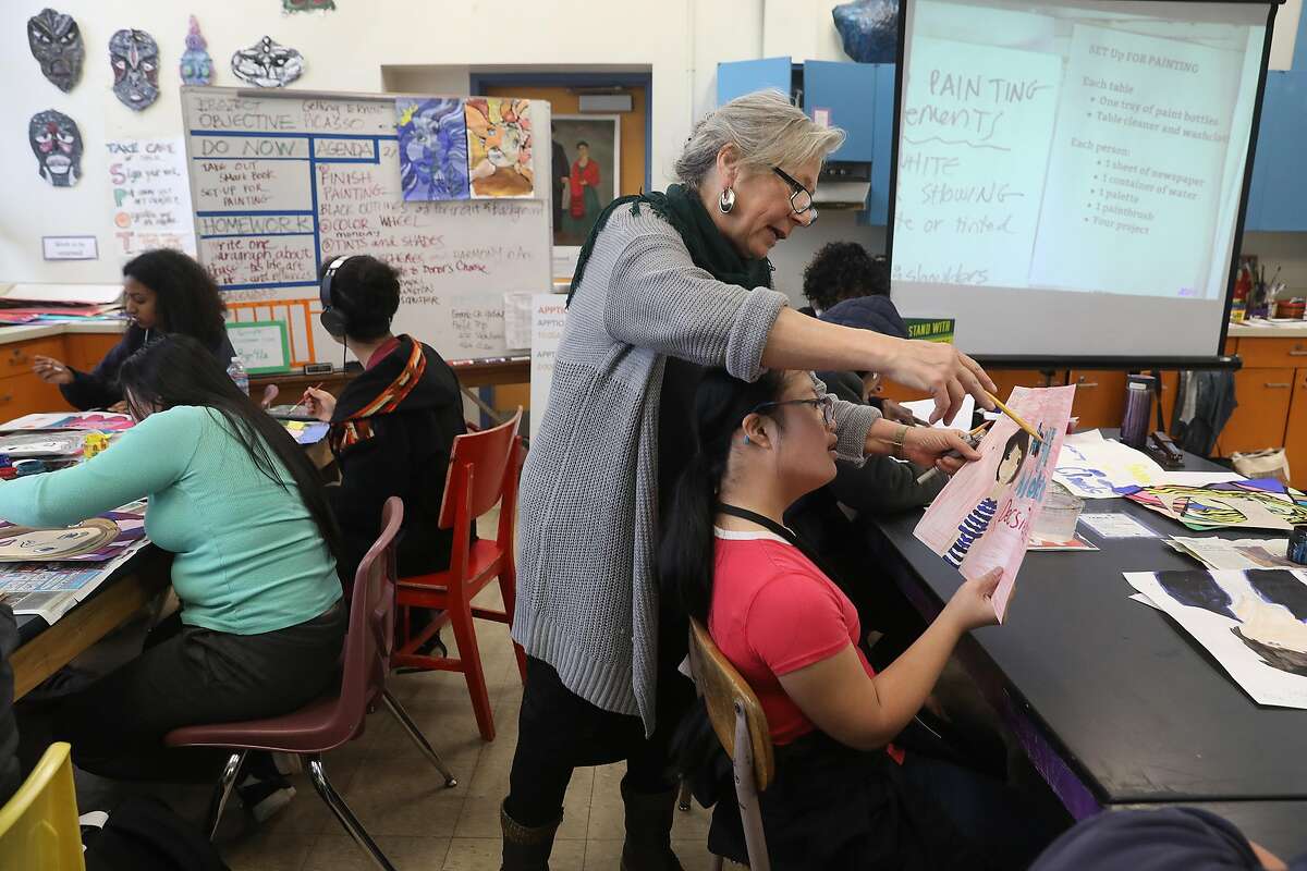 Art teacher Deborah Green (middle) talks with one of her students sophomore Amber Souk, 15 years old, at Oakland Technical High School on Wednesday, Feb. 13, 2019, in Oakland, Calif.