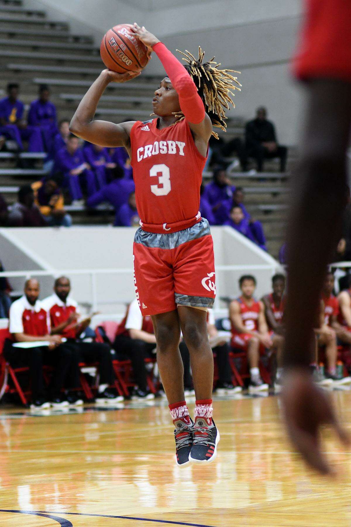 Crosby sophomore guard Deniquez Dunn gets off a three-point shot at the buzzer that was good against Barbers Hill in the 1st quarter of their Region III-5A Bi-District Playoff matchup at Phillips Fieldhouse in Pasadena on Feb. 19, 2019.