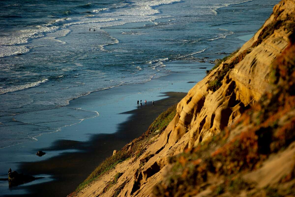 A news crew below at Fort Funston on Friday, Feb. 22, 2019, in San Francisco, Calif. A woman was rescued and another person is still buried and missing after a cliff collapse at Fort Funston.