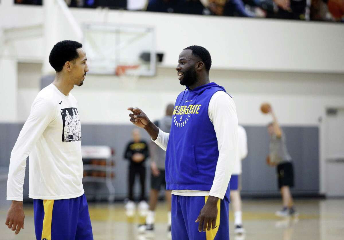 Golden State Warriors' Shaun Livingston (left) and Draymond Green converse during basketball practice at the Rakuten Performance Center in Oakland, Calif. on Wednesday, February 20, 2019.