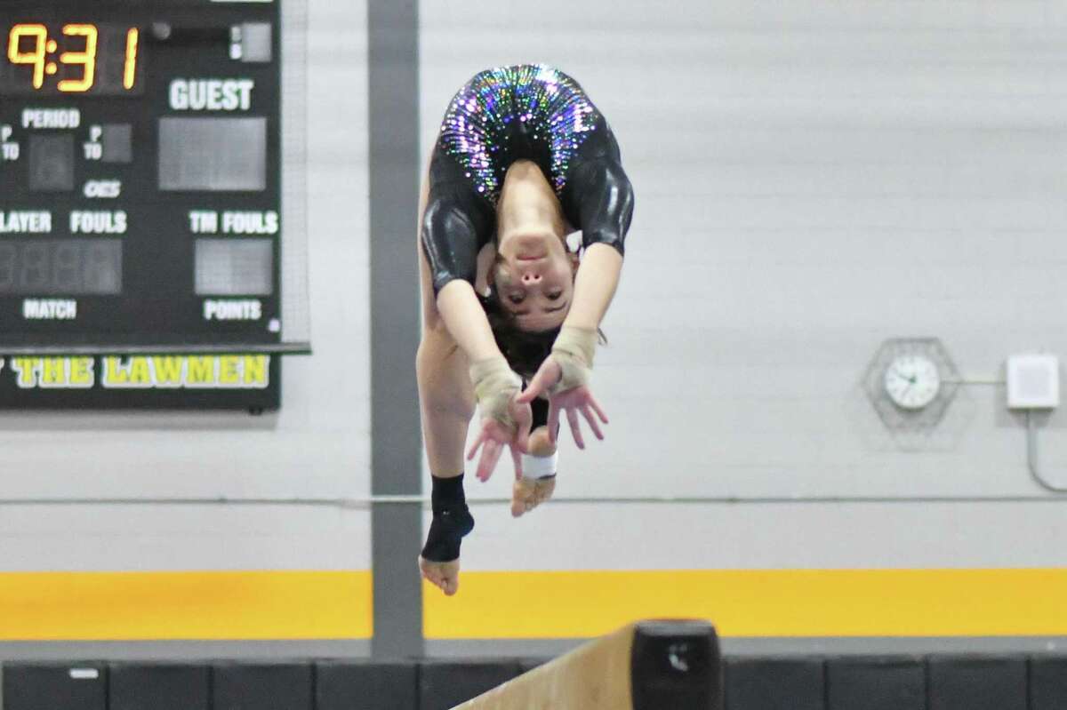 Thea Spinner of the New Milford Rebels competes on the Balance Beam during the CIAC Class M Gymnastics Championships on Saturday February 23, 2019 at Jonathan Law High School in Milford, Connecticut.