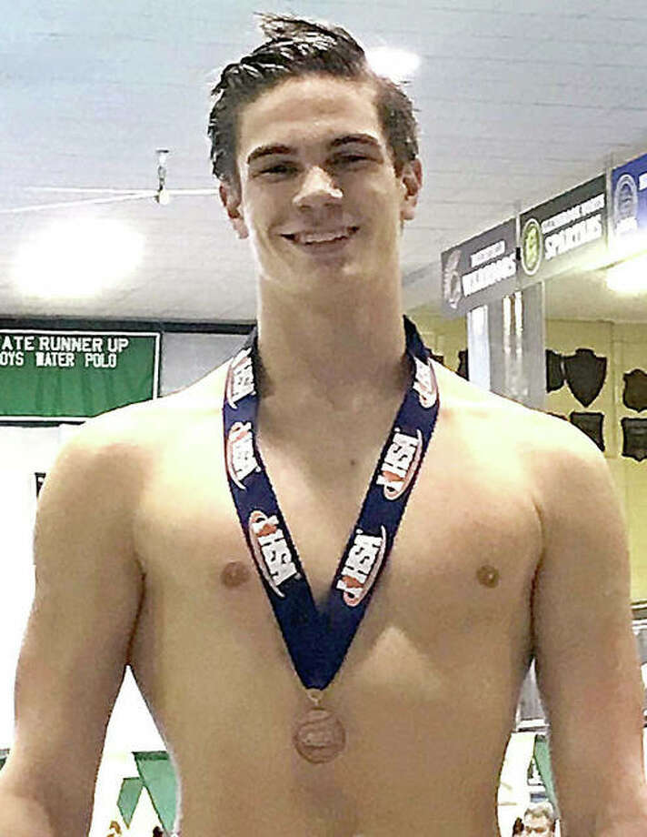 Alton High junior Noah Clancy with the third-place medal he won Saturday in the finals of the 100-yard backstroke at the IHSA Boys Swim and dive State Meet in Winnetka.