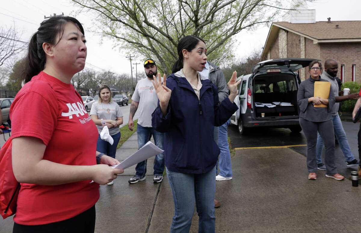 Tina Tran, left, listens with other staff and volunteers as Houston city council member Amanda K. Edwards, center, gives instructions before they all head out to canvas houses affected by the floods of Hurricane Harvey in the Kashmere Gardens neighborhood Saturday, Feb. 23, 2019 in Houston, TX.