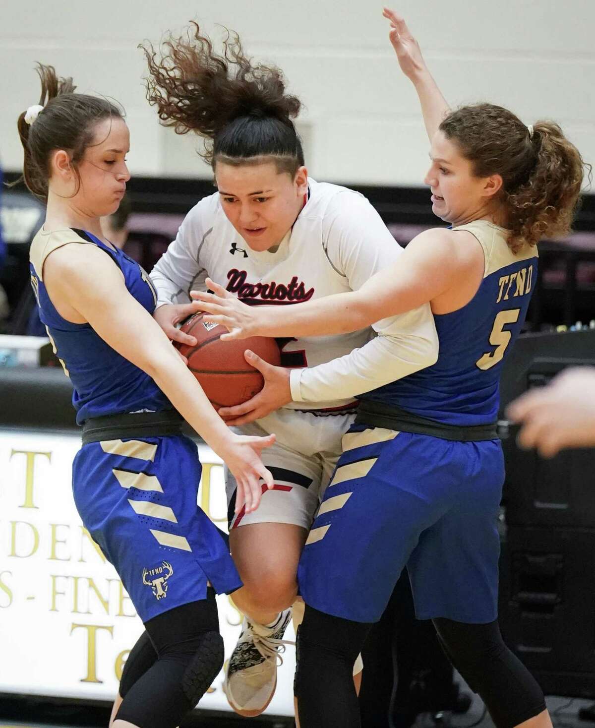 Veterans Memorial's Arianna Aguirre, center, tangles with Tivy's Katie Harmon, right, and Audrey Robertson during a girls high school basketball regional championship game, Saturday, Feb. 23, 2019, in San Antonio. Tivy won 44-34. (Darren Abate/Contributor)