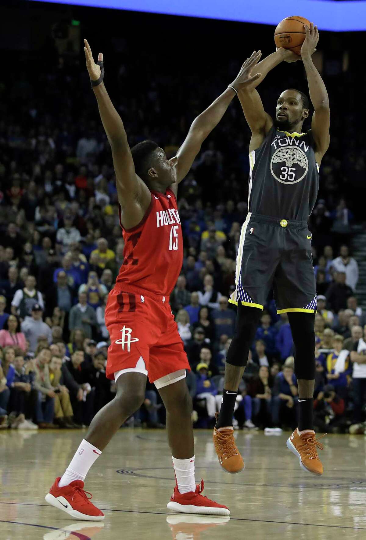 Golden State Warriors' Kevin Durant, right, shoots over Houston Rockets' Clint Capela, left, in the second half of an NBA basketball game Saturday, Feb. 23, 2019, in Oakland, Calif. (AP Photo/Ben Margot)