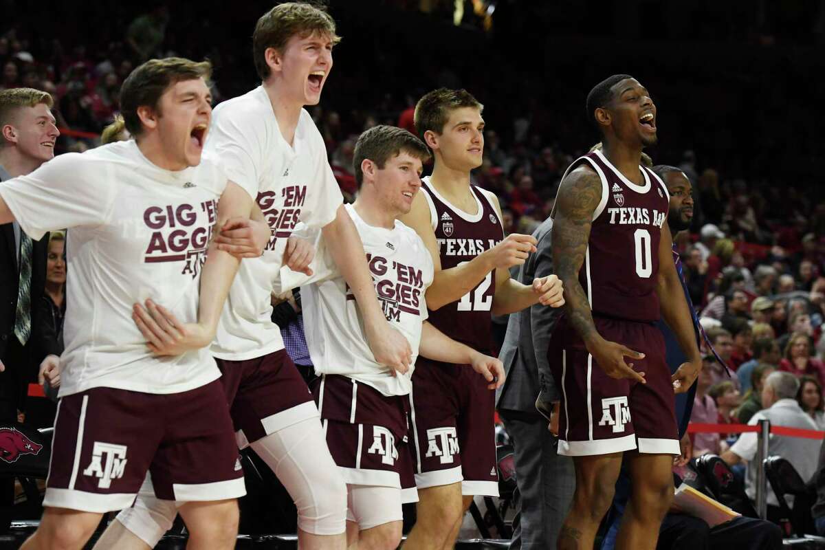 Texas A&M players react as their team rallies late in the second quarter during an NCAA college basketball game, Saturday, Feb. 23, 2019, in Fayetteville, Ark. (AP Photo/Michael Woods)