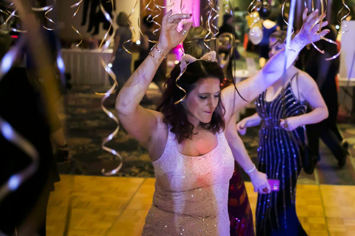Laura Brown dances on the dance floor during Mom Prom on Saturday, Feb. 23, 2019 at the Great Hall Banquet & Convention Center in Midland. (Katy Kildee/kkildee@mdn.net)