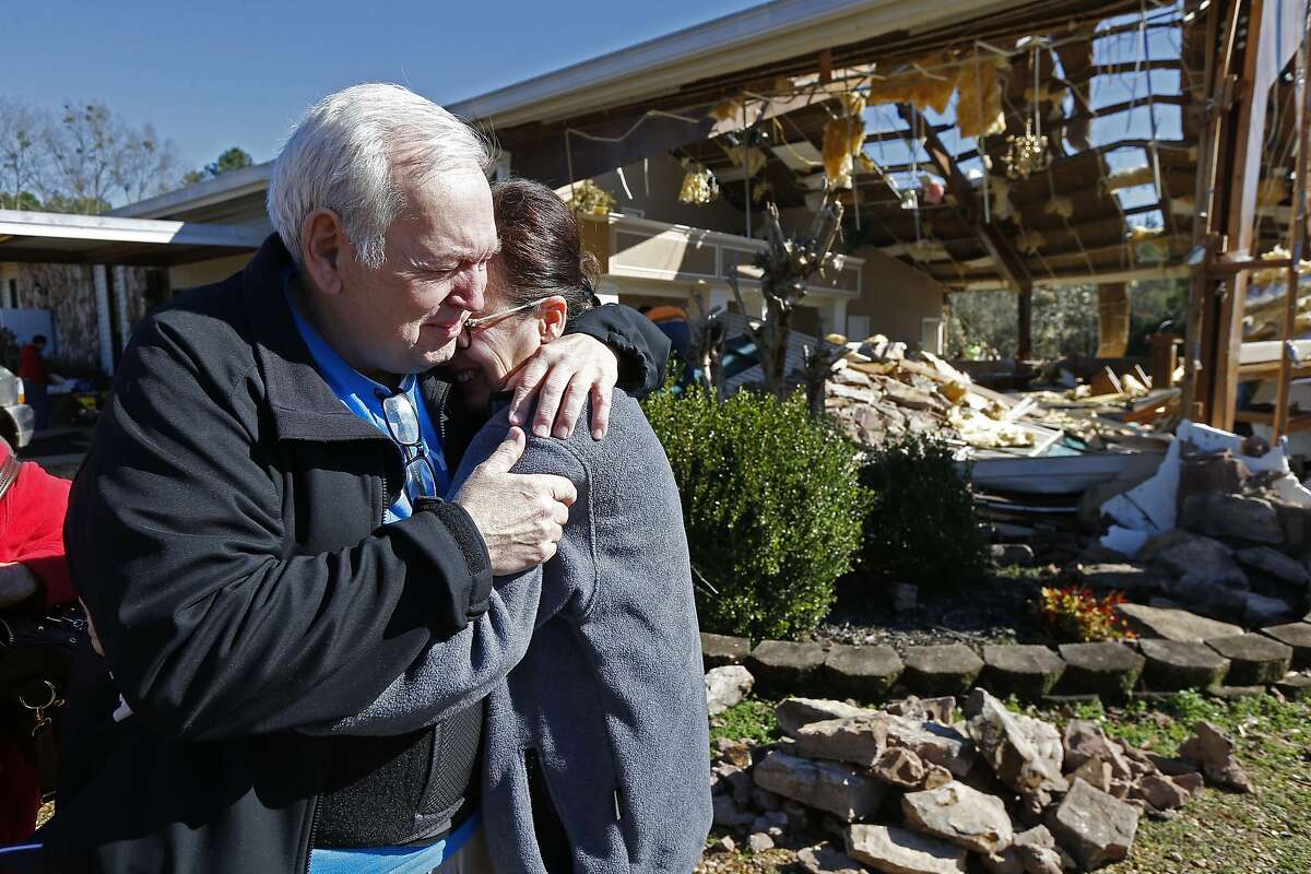 Pastor Steve Blaylock, left, comforts his wife Pat Blaylock, amid the rubble that was once the First Pentecostal Church in Columbus, Miss., Sunday morning, Feb. 24, 2019. A tornado Saturday wrecked havoc in the community, destroying a number of businesses as well as damaging and destroying homes. (AP Photo/Rogelio V. Solis)