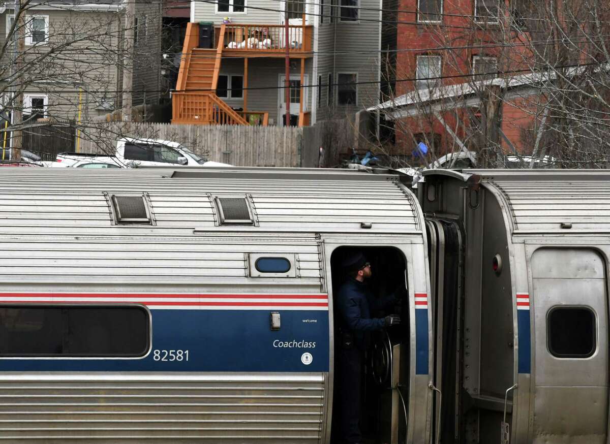 A train conductor stands in the doorway as a New York-bound Amtrak train pulls out of the Albany-Rensselaer train station on Monday Feb. 25, 2019, in Rensselaer, N.Y. (Will Waldron/Times Union)