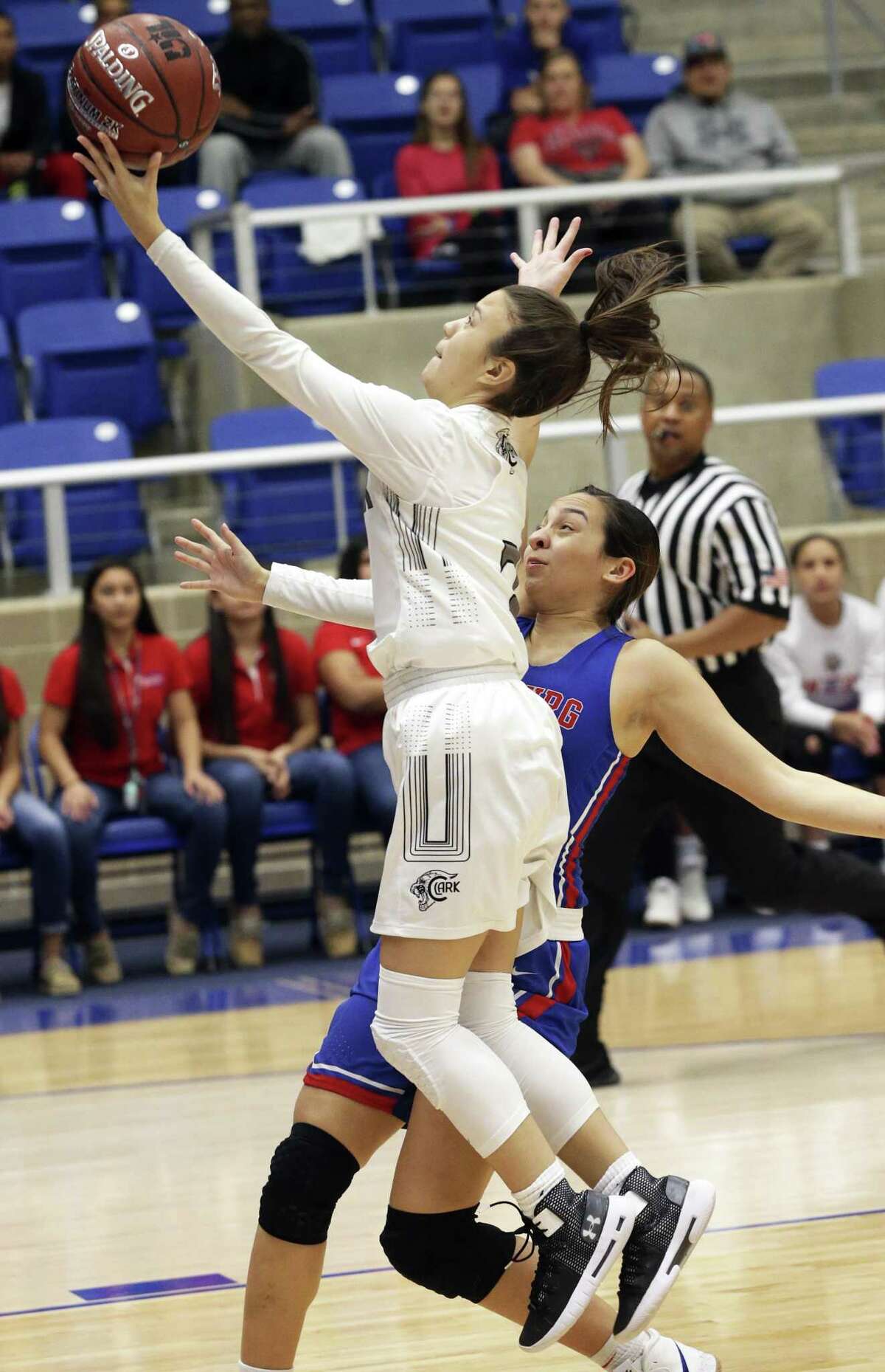 Cougar guard Sydney Solitaire scoops a layup after beating Alyssa Jade Salinas to the paint as Clark plays Edinburg in the Region IV-6A girls basketball tournament at Northside Gym on February 22, 2019.