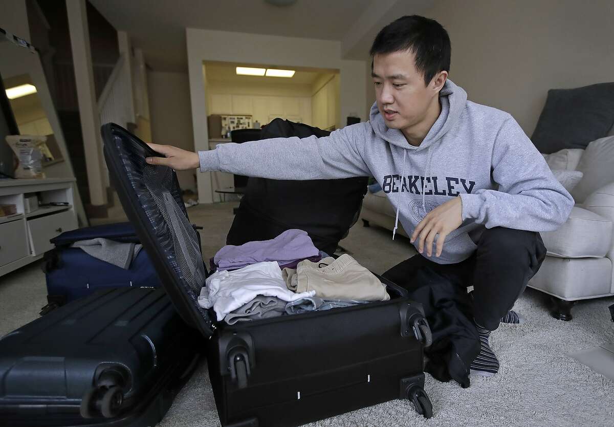 In this Monday, Feb. 4, 2019, photo, Leo Wang packs a suitcase at his home in San Jose, Calif. Wang has found himself trapped in an obstacle course regarding H-1B work visas for foreigners. His visa denied and his days in the United States numbered, Wang is looking for work outside the country. “I still believe in the American dream,” he says. “It’s just that I personally have to pursue it somewhere else.” (AP Photo/Ben Margot)