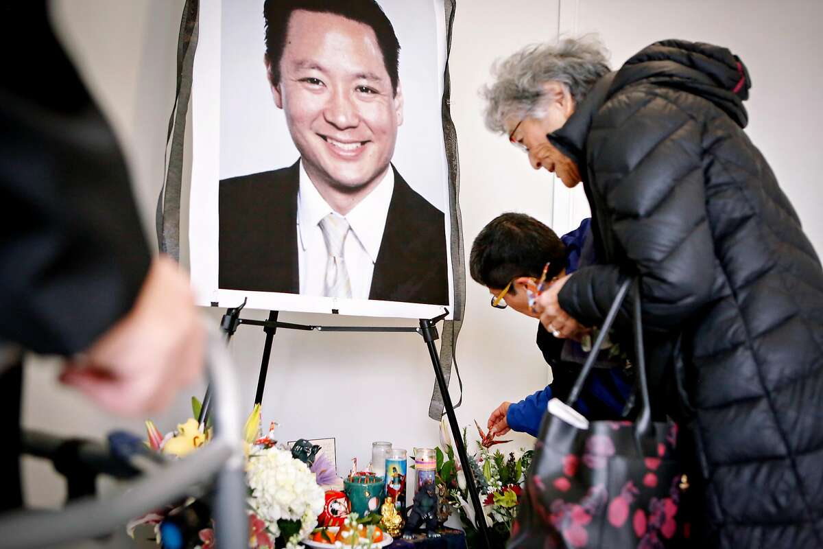 (L to R) Friends Paul Osaki, Teresa Ono, and Marjorie Fletcher pay their respects at a memorial for Jeff Adachi at the San Francisco Public Defender's Office on Monday, February 25, 2019 in San Francisco, Calif.