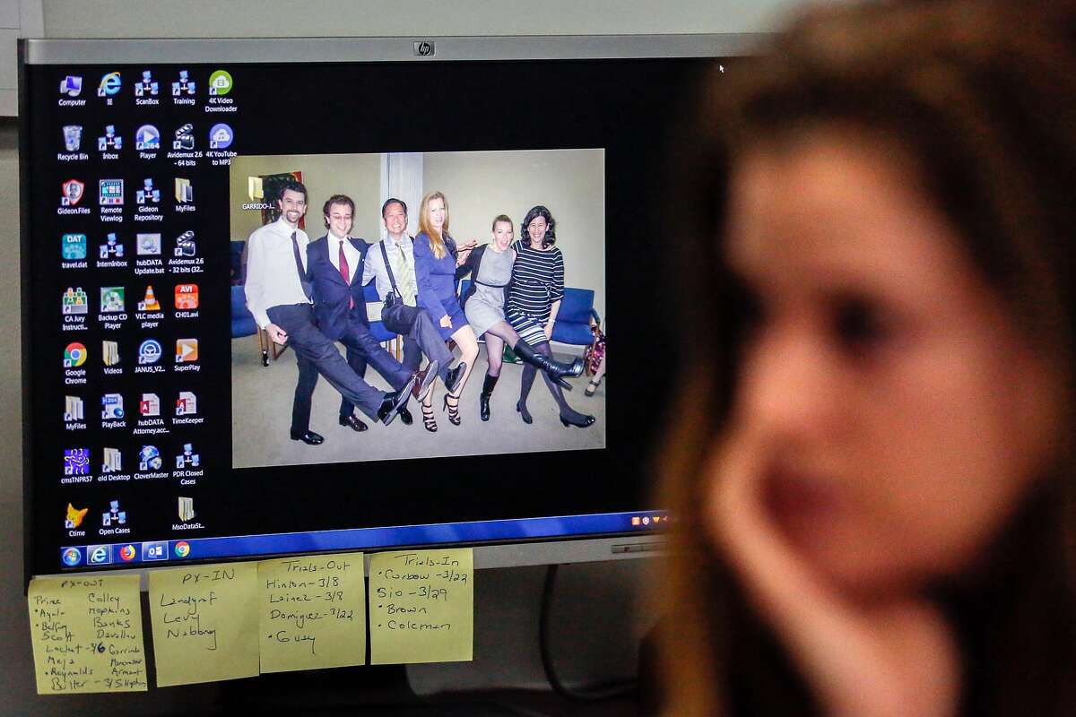 Attorney Elizabeth Hilton's desktop displays a photo of Jeff, her, and other colleagues as she speaks with a reporter at the San Francisco Public Defender's Office on her first day back at work since his boss, Jeff Adachi, died Friday night on Monday, February 25, 2019 in San Francisco, Calif.