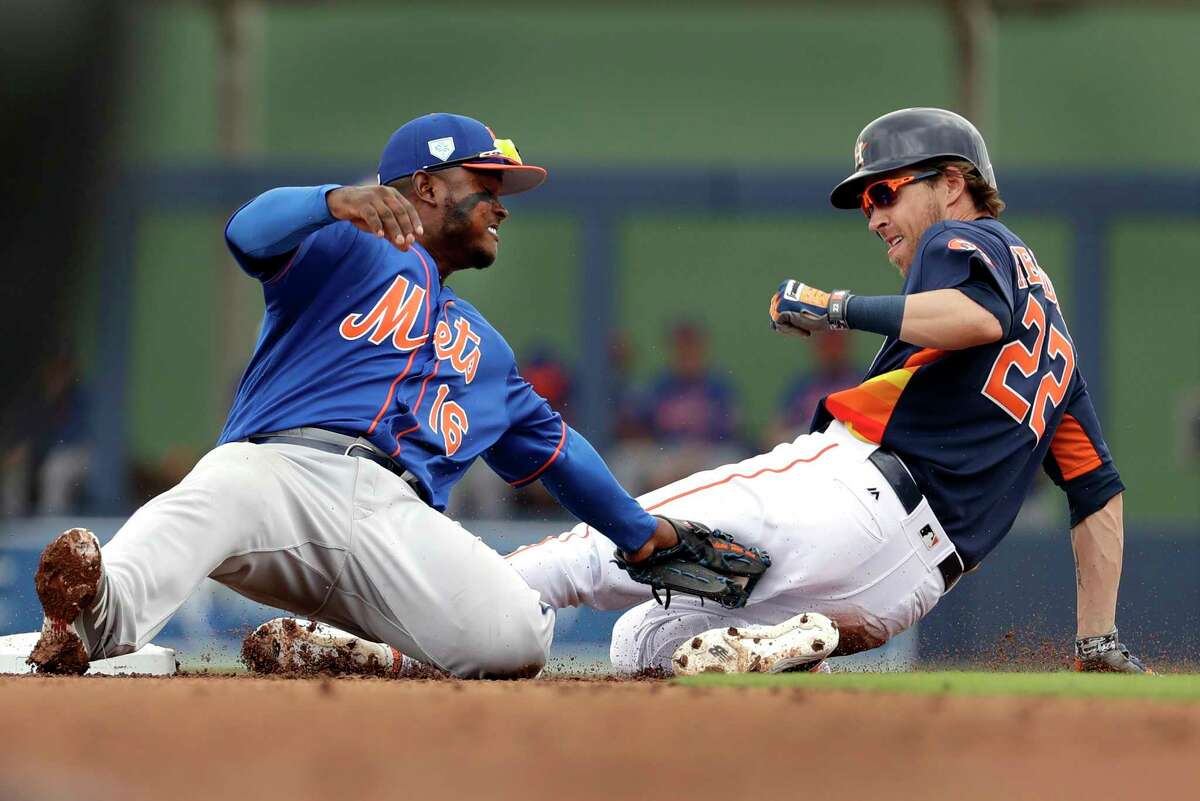 Houston Astros' Josh Reddick (22) is tagged out by New York Mets second baseman Dilson Herrera on a stolen base attempt during the first inning of an exhibition spring training baseball game Monday, Feb. 25, 2019, in West Palm Beach, Fla. (AP Photo/Jeff Roberson)