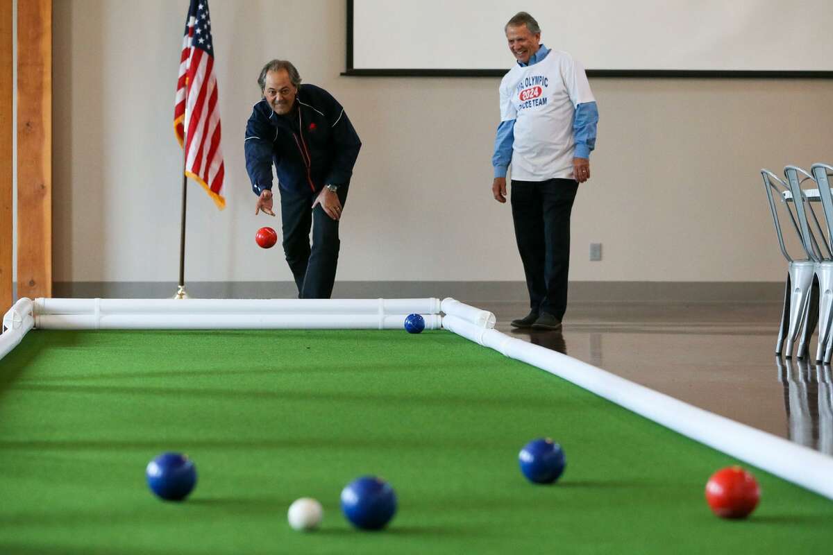 Dan Kilian (left) tries to throw his bocce ball as close as possible to the pallino (smaller white ball) while playing a game of bocce ball with Bruce Barnard at Bella on the Vine adjacent to Papa Dante's Restaurant at 8607 FM 1976 on Feb. 7.
