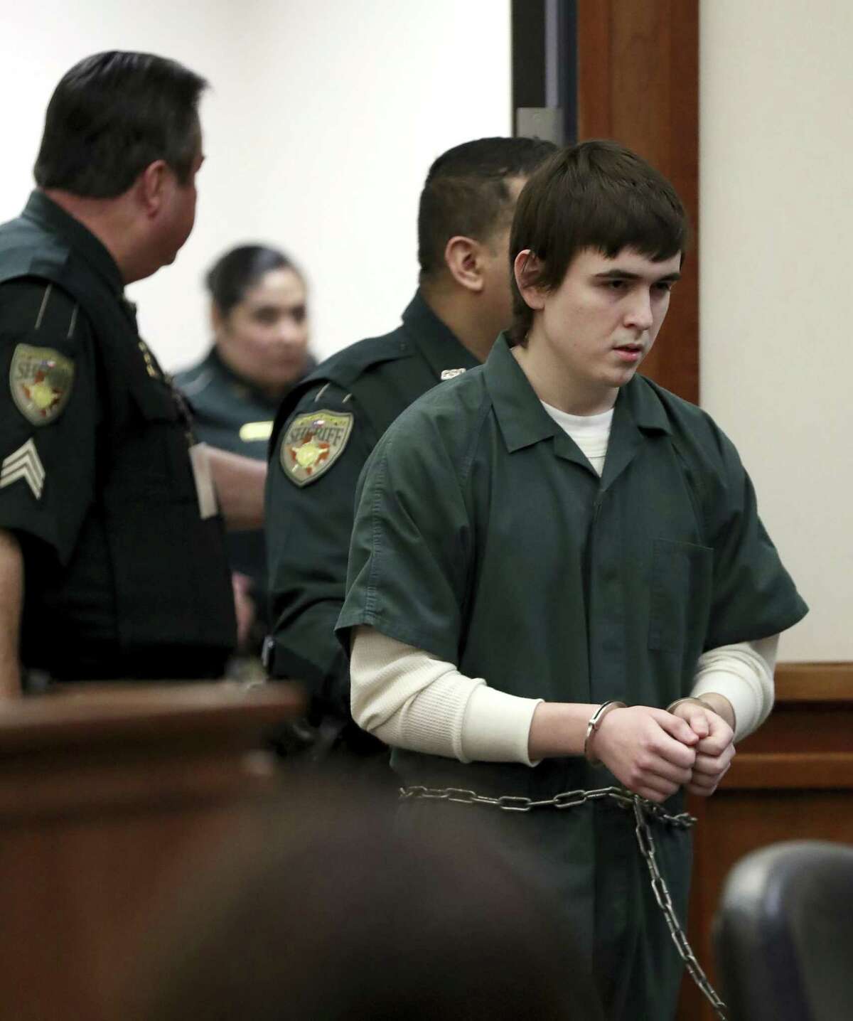 Dimitrios Pagourtzis, the Santa Fe High School student accused of killing 10 people in a May 18 shooting at the high school, is escorted by Galveston County Sheriff's Office deputies into the jury assembly room for a change of venue hearing at the Galveston County Courthouse in Galveston, Texas on Monday, Feb. 25, 2019. The trial of Pagourtzis may be delayed for a year as federal investigators have yet to deliver key evidence, prosecutors said Monday.