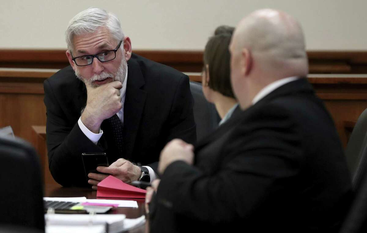 Defense attorney Robert Barfield talks with attorneys Katy-Marie Lyles and Nicholas Poehl before the change of venue hearing for their client Dimitrios Pagourtzis, the Santa Fe High School student accused of killing 10 people in a May 18 shooting at the school, at the Galveston County Courthouse on Monday, Feb. 25.