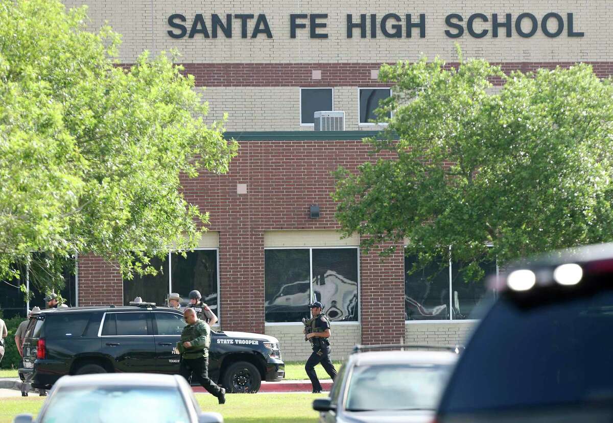 FILE - In this May 18, 2018, file photo, law enforcement officers respond to Santa Fe High School after an active shooter was reported on campus in Santa Fe, Texas. The parents of Dimitrios Pagourtzis, accused of killing 10 people at the Southeast Texas high school, say they were not negligent and that they did as much as they could for their son, according to their attorney. A judge on March 11, 2020 ordered that Pagourtzis continue to be evaluated at a mental health facility for up to a year to see if he regains competency to stand trial.
