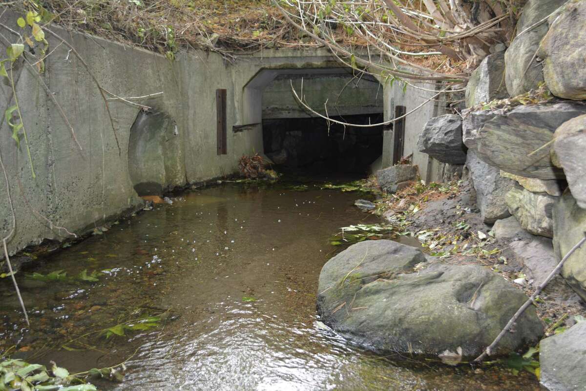 The tunnel opening into which the “Gilbert Home Brook" flows under Hinsdale School.