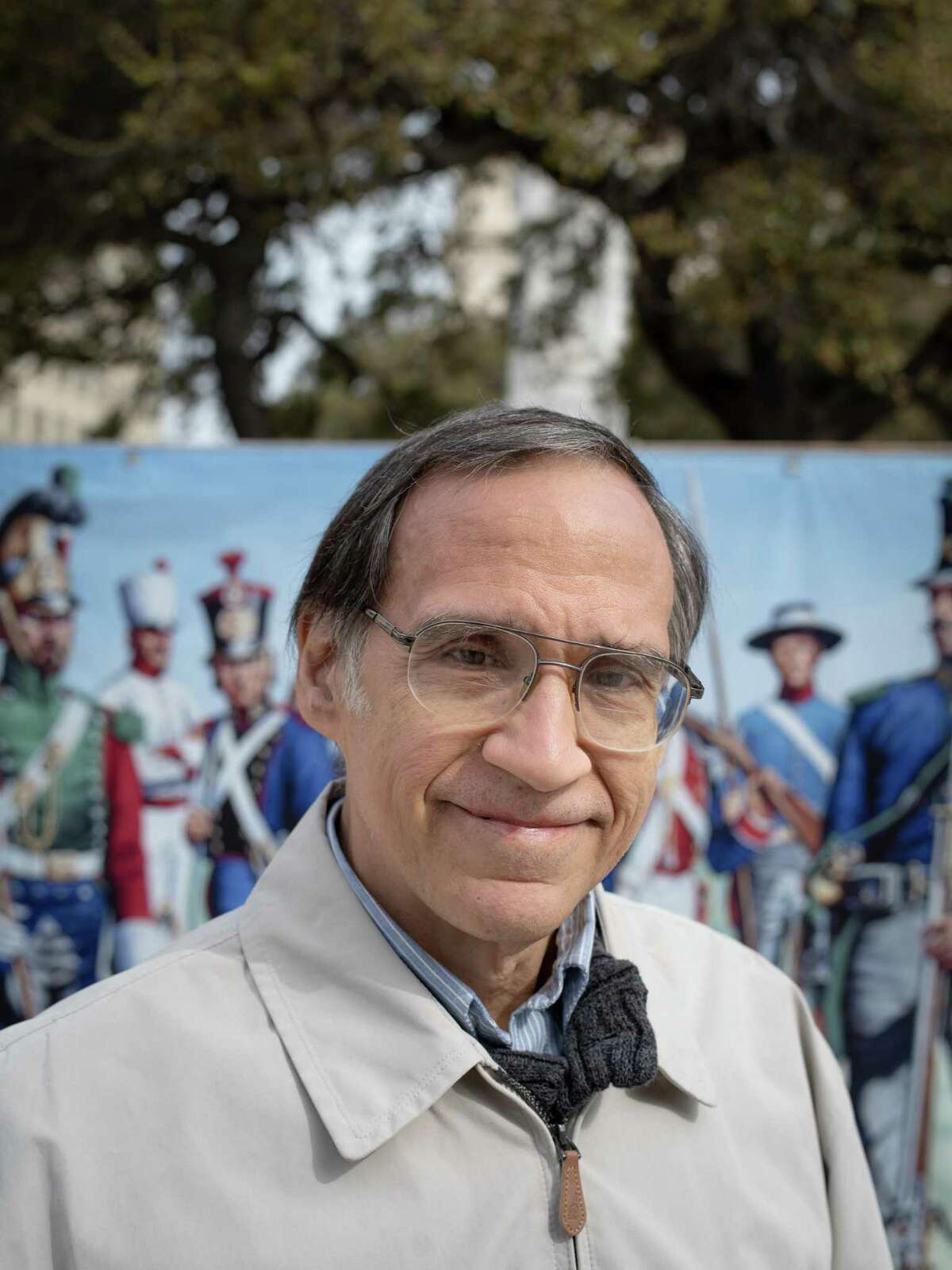 Gary Zaboly, an historical artist and illustrator, poses for a portrait in front of an enlarged version of his work in Alamo Plaza where representations of his work are displayed on Monday, February 25, 2019. Zaboly has been depicting the Alamo, its occupants, defenders and attackers in his work since the 1990s. Many of his works are owned and displayed in the Alamo's Wall of History on the premises.
