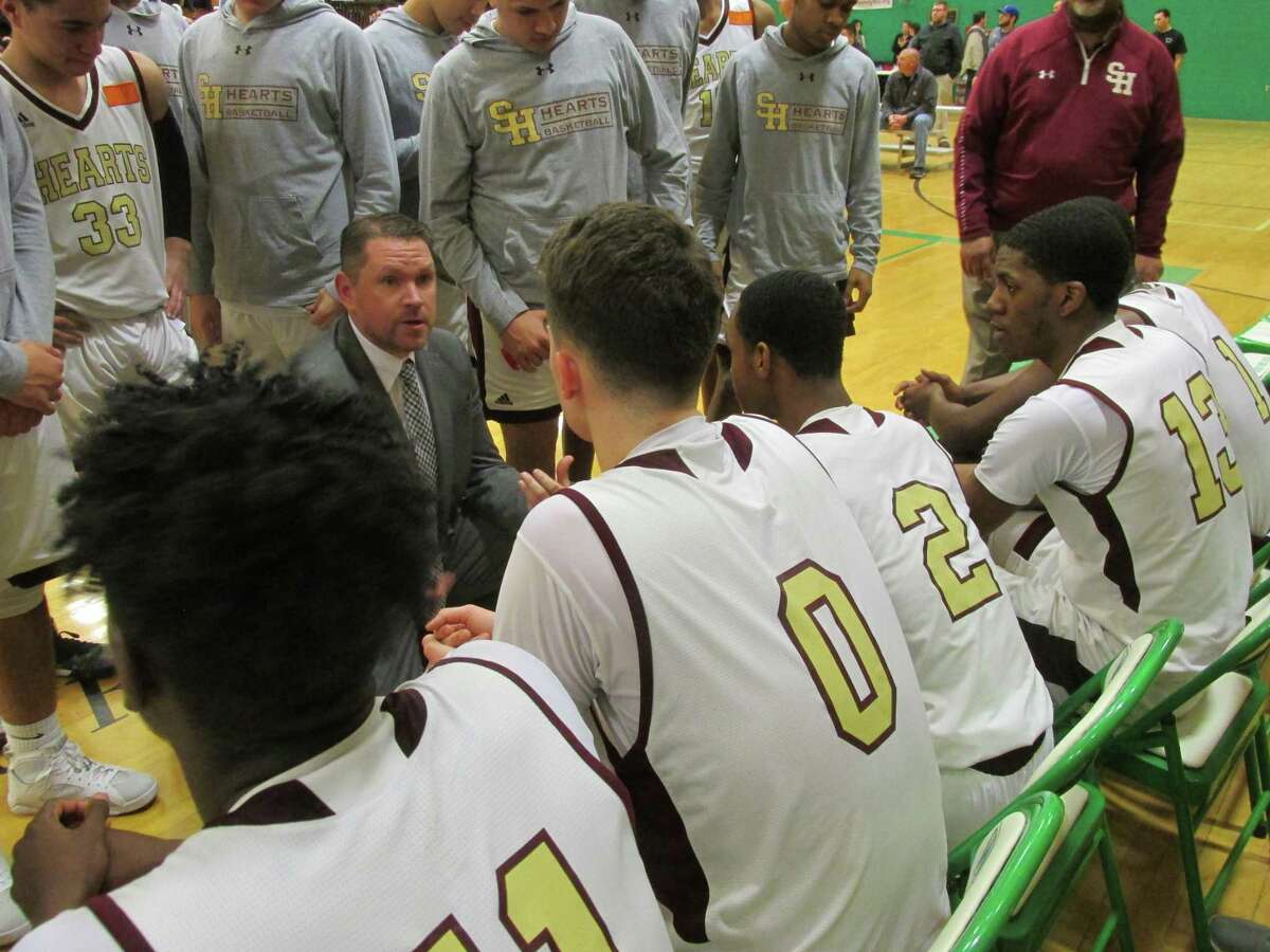 Sacred Heart coach Jon Carroll sets the defense for the Hearts in their win over WCA in the NVL’s second semifinal Monday night at Wilby High School. Carroll was named the new girls basketball coach at Naugatuck this week.