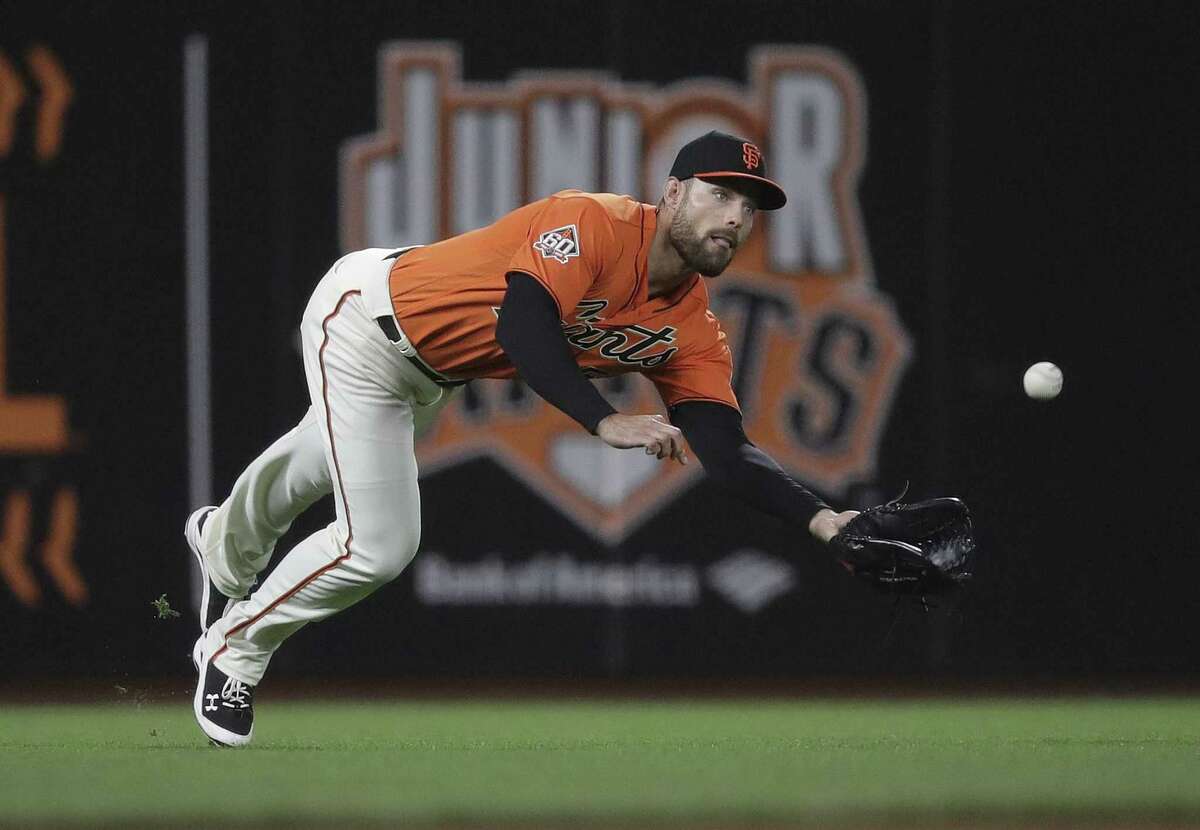 San Francisco Giants left fielder Mac Williamson makes a diving catch on a line drive from San Diego Padres' Clayton Richard during the seventh inning of a baseball game Friday, June 22, 2018, in San Francisco.