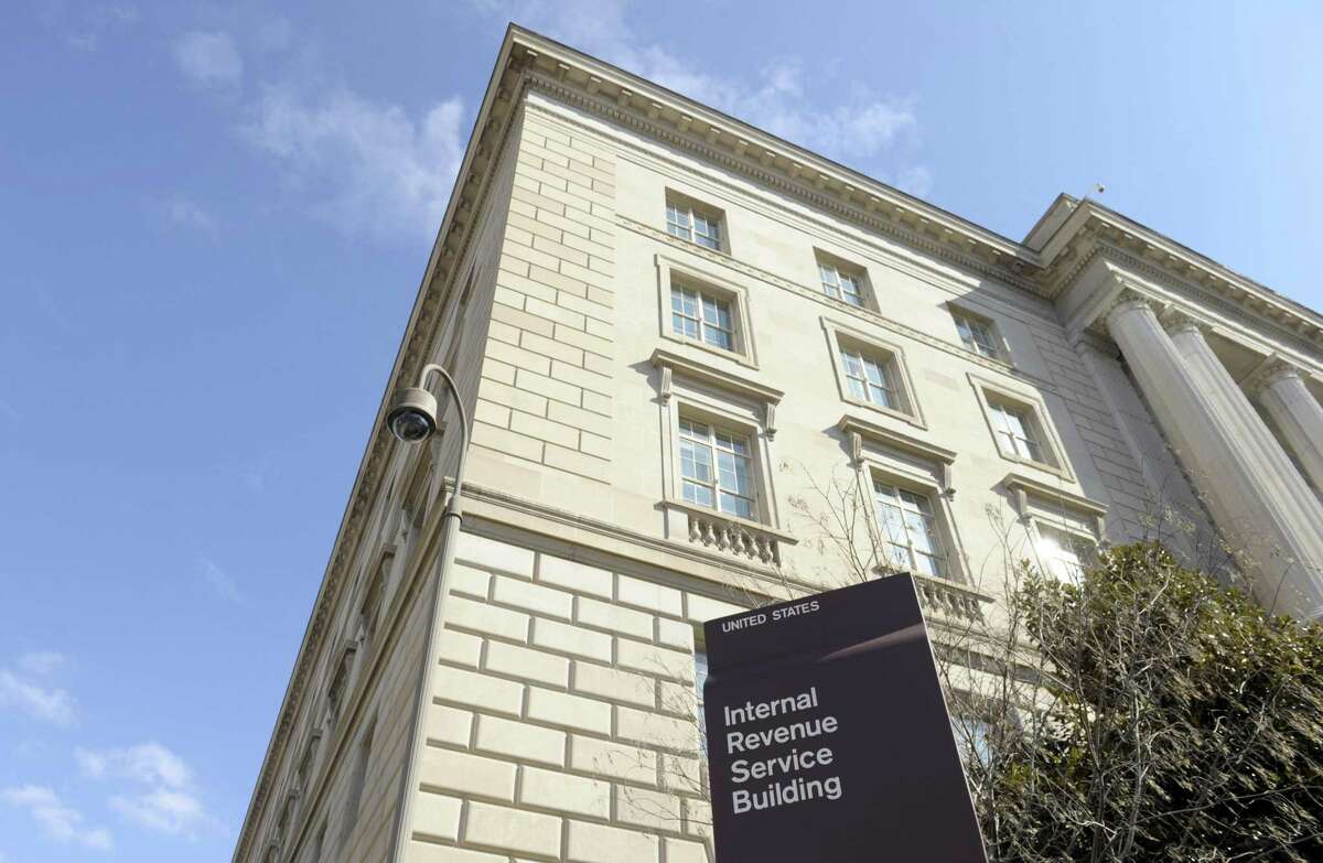 FILE - This March 22, 2013, file photo, shows exterior of the Internal Revenue Service building in Washington. Fake IRS agents have targeted more than 366,000 people with harassing phone calls demanding payments and threatening jail as part of a huge nationwide tax scam that has cost taxpayers $15.5 million. More than 3,000 people have fallen for the ruse since 2013, Timothy Camus, a Treasury deputy inspector general for tax administration, said Thursday, March 12, 2015. (AP Photo/Susan Walsh, File)