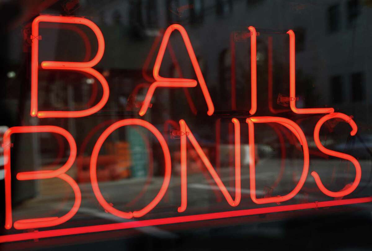 FILE - This July 7, 2015, file photo, shows a sign advertising a bail bonds business in the Brooklyn borough of New York. A new Texas nonprofit promoting crime victims’ rights is opposing bipartisan efforts to end cash bail systems that have gained traction around the country - hitting back at one of the few issues that unified advocates on both the right and left. Kicking off Thursday, Feb. 15, 2018, the Texas Alliance for Safe Communities wants to strengthen public safety and curb violent crime. (AP Photo/Kathy Willens, File)