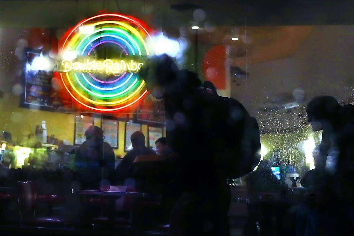 Pedestrians walk past Double Rainbow ice cream shop on Fourth Street in San Rafael, Calif., on Monday, February 25, 2019.