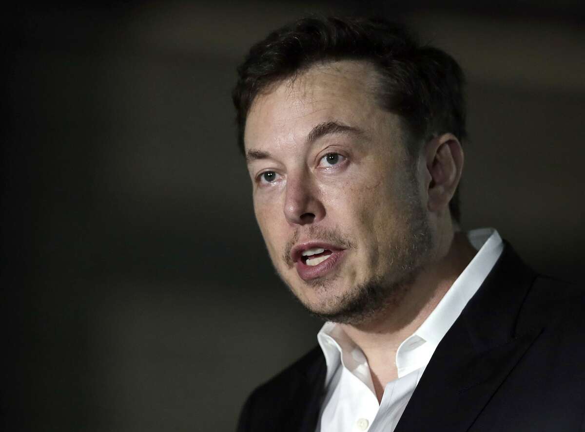 FILE - In this June 14, 2018, file photo, Tesla CEO Elon Musk speaks at a news conference in Chicago. Stock market regulators are asking a federal court to hold Musk in contempt for violating an agreement requiring him to have his tweets about key company information reviewed for potentially misleading claims. The request made Monday, Feb. 25, 2019 in New York resurrects a dispute between the Securities and Exchange Commission and Musk that was supposed to have been resolved with a settlement reached five months ago. (AP Photo/Kiichiro Sato, File)