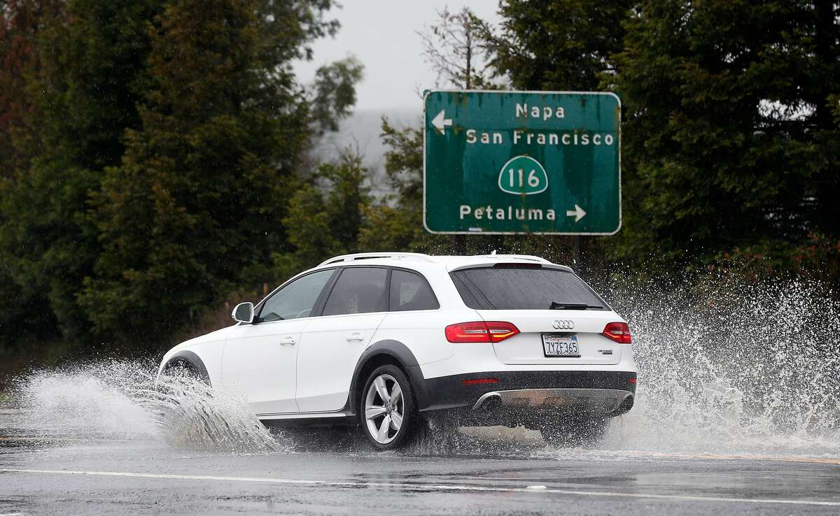A motorist drives through deep standing water on Arnold Drive near Stage Gulch Road during the heavy rainstorm in Sonoma, Calif. on Tuesday, Feb. 26, 2019.